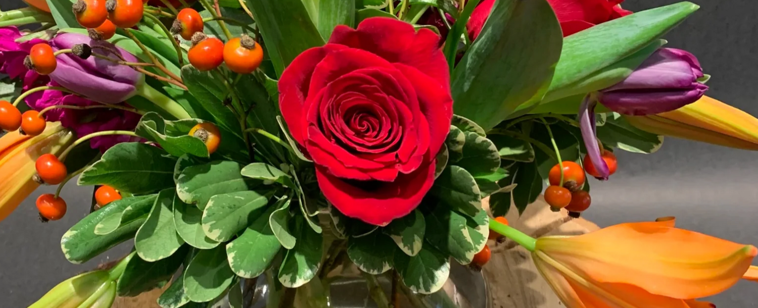 A rose, lilies, and more in an arrangement to illustrate Mother's Day Flowers ideas.